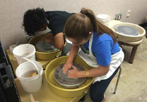 Students creating pottery